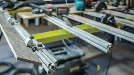 Close-up of a tile being cut with a professional tile saw in a workshop
