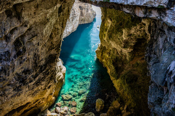 Gaeta, Latina, Lazio, Italy. A splendid view of the city. The ancient village with its houses overlooking the sea. The spectacular Grotta del Turco on the Montagna Spaccata (Split Mountain) cliff. © Ragemax