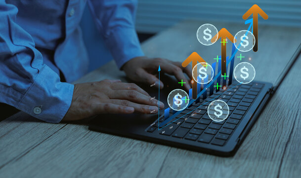 Businessman standing typing on laptop growth financial success rising charts and money for related to investment, economic trends, digital finance, profit analytic concepts
