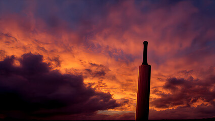 Cricket bat and ball arranged on vintage wooden bench in traditional cricket club setting with period details