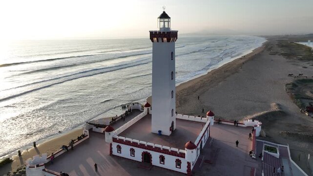Drone footage of Faro Monumental lighthouse on the beach in La Serena, Chile