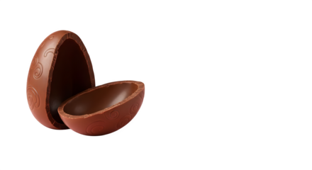 Close up of a broken chocolate egg with designs on the shell against a black background studio shot