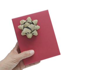 Woman hand holding red gift box with gold glitter bow over transparent background. Top view concept of giving present for Christmas, Valentine or birthday celebration with copy space for text.