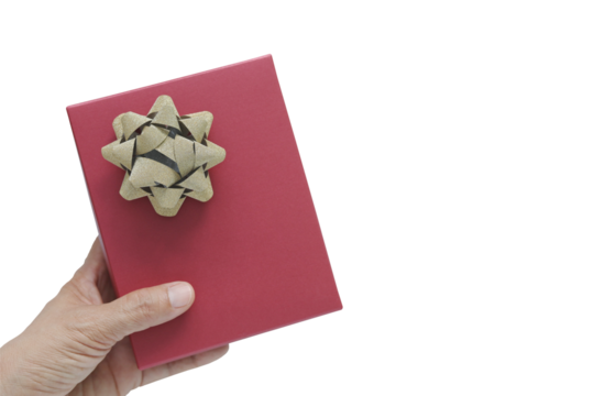 Woman hand holding red gift box with gold glitter bow over blue wooden background. Top view concept of giving present for Christmas, Valentine or birthday celebration with copy space for text.