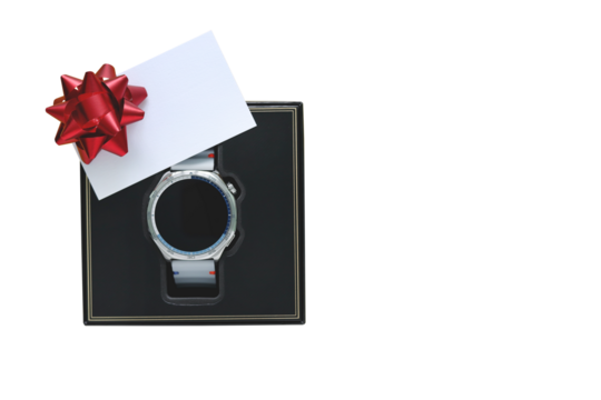 Modern silver smartwatch in black box with blank white card and red bow isolated on yellow background. Top view flat lay of technology gift for Father's Day or birthday present, holiday concept.