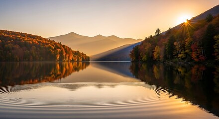 Golden hour reflection of colorful autumn foliage on a tranquil lake with distant mountain peaks bathed in sunlight