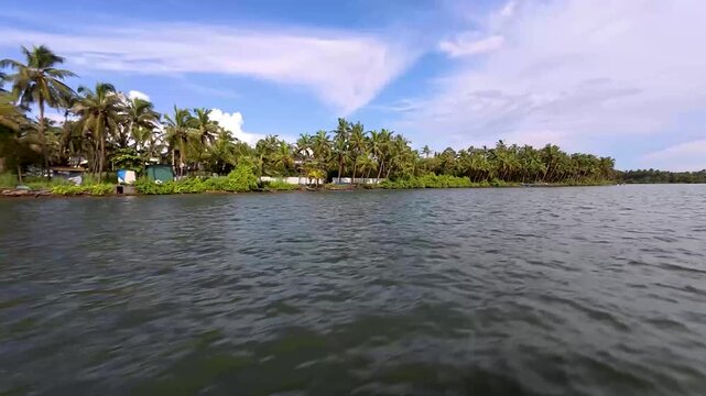Kannur, Kerala, India-October 3 2025; A Picturesque view of the Kerala backwaters with coconut, palm trees and scenic location at Alleppey in India.
