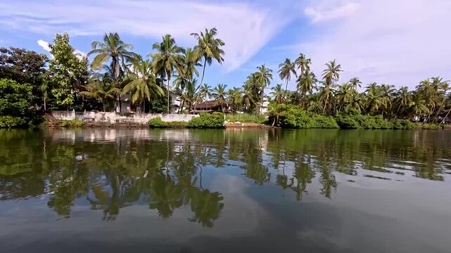 Kannur, Kerala, India-October 3 2025; A Picturesque view of the Kerala backwaters with coconut, palm trees and scenic location at Alleppey in India.
