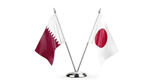 Two national flags qatar and japan displayed on a metal stand isolated on white background
