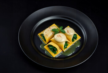 Ravioli with Spinach and Parmesan Foam on Black Plate