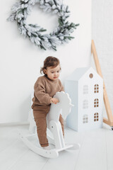 little boy playing with a toy house