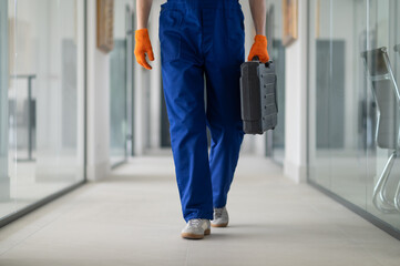 Worker walking with briefcase indoors