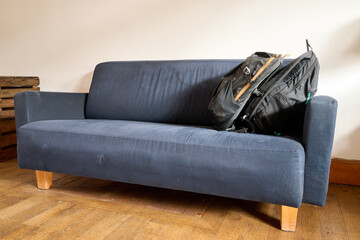 backpacks on the blue sofa