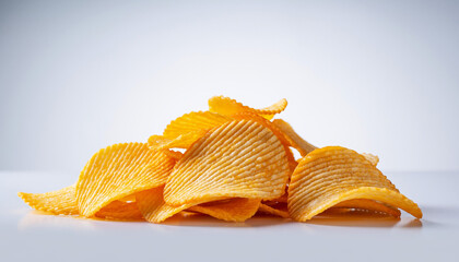 Pile of crunchy, golden potato chips with a ridged texture, isolated on a white background, perfect for snack advertising