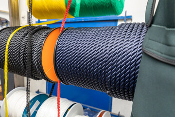 Colorful braided ropes on spools in a hardware store