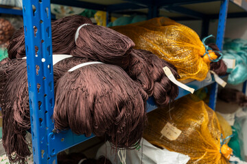 Fishing nets and fishing gear stored on blue shelves