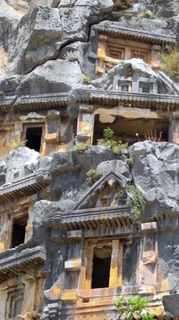 Rock-cut tombs of the ancient Lycian necropolis. Myra is an antique town in Lycia where the small town of Kale (Demre) Turkey. Close-up of rock cut tomb grave.