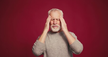 Sad stressed senior man having headaches illness retired male having increased intracranial pressure