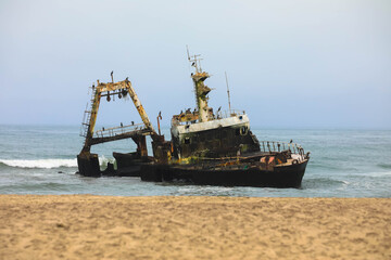 Zeila shipwreck, a haunting skeletal frame embraced by the turbulent Atlantic along the Skeleton Coast near Henties Bay. Zeila was an offshore fishing vessel that ran aground in 2008. Namibia