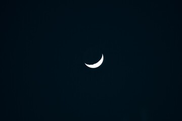 Dark black background with white crescent moon silhouette