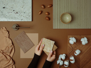 A warm, earthy-toned material board featuring natural textures, cotton flowers, and neutral...