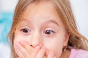 child covering mouth with hands, expressing fear speaking, shyness, social anxiety, struggle begin articulation, expressing silence, suppress cough or sneeze, Childhood shyness and secret keeping