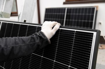 Technician working on solar panel installation at a residential setting in the daytime © Kokhan O