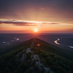 Dramatic sunset over a winding river and mountain ridge