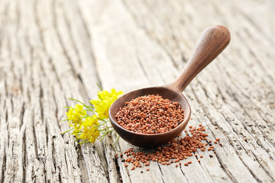 Camelina seeds on wooden board