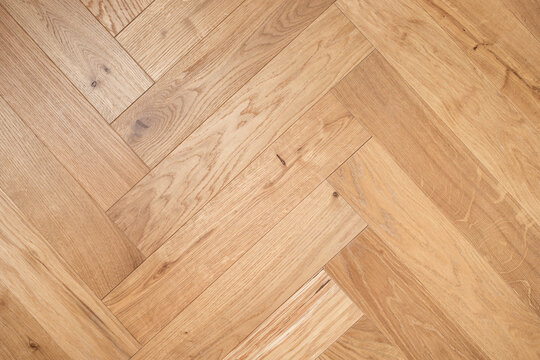 Natural wooden oak parquet flooring background. Rustic floor pattern for interior and indoor home design.
