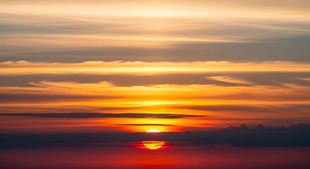 Vibrant sunset over the ocean with dramatic clouds and reflections