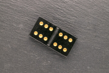 Old dice for playing dominoes, top view, macro.