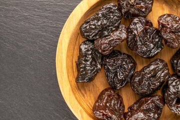 Dried sweet prunes, top view, macro.