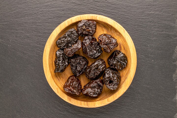 Dried sweet prunes, top view, macro.