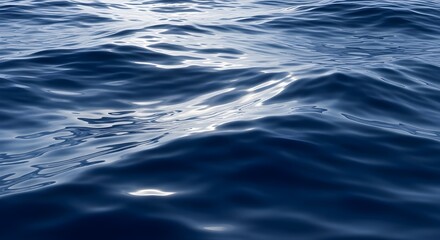 Deep blue ocean water with sunlight reflecting on the surface