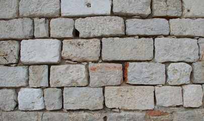 High-resolution close-up of a stacked stone wall showing rough, natural textures, irregular shapes, and earthy tones—ideal for backgrounds, architectural design, construction materials, and texture