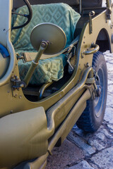 Close Up Of Olive Drab Military Jeep Interior With Seat Cover And Side Mirror