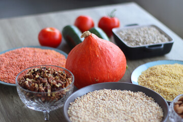 Assortment of various healthy fruits, vegetables, grains and legumes. Selective focus, wooden background.
