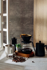 Coffee Brewing Setup with Fresh Coffee Beans and Green Plant Decor