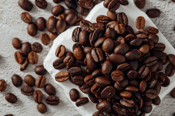 Freshly Roasted Coffee Beans on White Surface with Texture Background