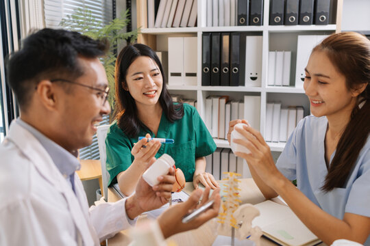 Group of doctors and nurses consulting about a complex patient case in hospital office. Team analyzing medical data and discussing diagnostic plans for accurate and efficient treatment.
