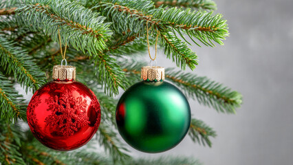 Beautifully decorated Christmas tree ornaments hanging from lush evergreen branches in a cozy holiday setting