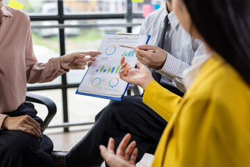 Business team analyzing financial data during office meeting.