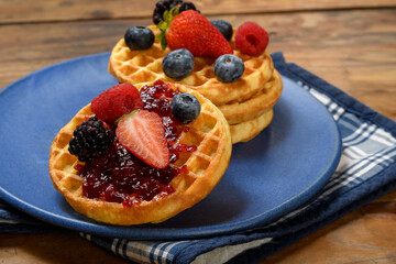 Golden Waffles Topped with Berry Jam and Fresh Fruit