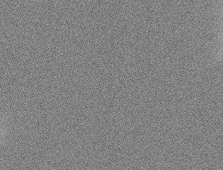 dense monochrome static pattern creates a gritty noisy surface reminiscent of an old retro