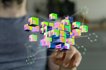 Hand reaching towards a cluster of colorful 3D cubes, symbolizing connection, data, and digital transformation.