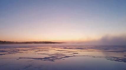 Frozen lake at sunrise with pastel sky and mist rising from the ice Keywords: winter, sunrise, frozen lake, ice, snow, mist, fog - Powered by Adobe