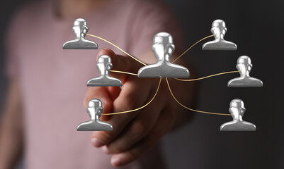 Visual representation of business network and human connections, hand pointing, team building concept with person symbols.