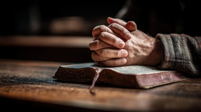 Man praying with a Bible in the morning hands clasped in church reflecting faith and spirituality