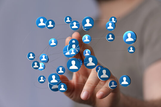 Person holding connected digital network icons representing social media connection, global communication, teamwork and collaboration.